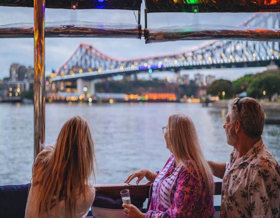 Brisbane: Sunset City Lights Cruise 5.30pm or 6pm <em>seasonal – Key points to know before booking’ /></p>
<ul>
<li><strong>The cruise changes with the seasons:</strong> Departures are at 5:30pm from April 1 to September 30, and 6pm from October 1 to March 31.</li>
<li><strong>The city lights are the main event:</strong> Story Bridge, Kangaroo Cliffs, bridges, and the Brisbane skyline take center stage after dark.</li>
<li><strong>A charcuterie share board is included:</strong> You receive complimentary nibbles, while drinks and extra snacks cost more.</li>
<li><strong>The mood is relaxed rather than tour-guide focused:</strong> Background music replaces live commentary.</li>
<li><strong>South Bank is the easy starting point:</strong> Meet at the Cultural Centre Public Pontoon, in front of the cultural centre.</li>
<li><strong>It costs $41 per person:</strong> That is fair for a 1.5-hour cruise with a food board, though a free CityCat ride offers a cheaper river view.</li>
</ul>
<h2>Setting off from South Bank at the right time</h2>
<p><img width="900" height="675" decoding="async" src=