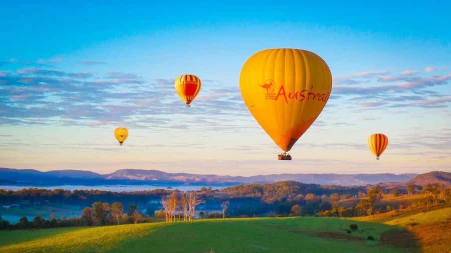 Gold Coast: Hot Air Balloon Flight and Vineyard Breakfast - Watching a balloon rise above the field