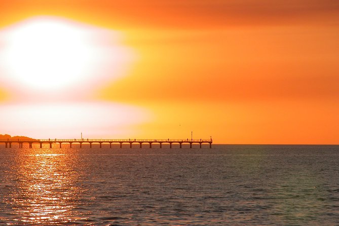 Hervey Bay Champagne Sunset Sail - The Fraser Island view at golden hour