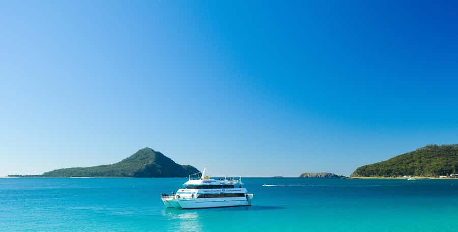 Sydney: Port Stephens Dolphin Cruise & Sandboarding Day Trip - Stockton Beach and the long slide down the dunes