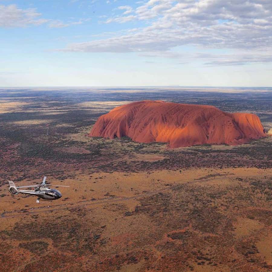 Uluru 15-Minute Helicopter Experience - Boarding the helicopter and getting ready for takeoff